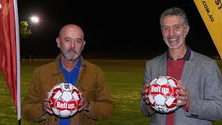 Two men holding soccer balls